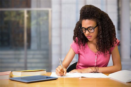 Composite image of student sitting in library writing Photographie de stock - Aubaine LD & Abonnement, Code: 400-08379719