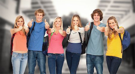 Composite image of smiling group giving a thumbs up as they wear backpacks Stock Photo - Budget Royalty-Free & Subscription, Code: 400-08379768