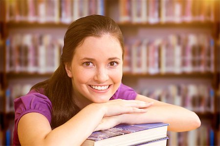 simsearch:400-07267978,k - Portrait of female student in library against books on desk in library Stock Photo - Budget Royalty-Free & Subscription, Code: 400-08379984