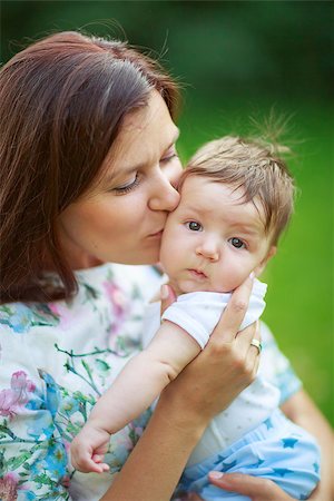 family healthy candid - Mother kisses baby son, close-up, summer photos outdoor Stock Photo - Budget Royalty-Free & Subscription, Code: 400-08370711