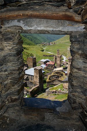 simsearch:400-07574451,k - Ushguli village view through a tower window. Ushguli  is a community of villages located at the head of the Enguri gorge in Upper Svaneti, Georgia (Caucasus Mountains). Altitude is 2,410 metres (7,910 ft). Photographie de stock - Aubaine LD & Abonnement, Code: 400-08370755