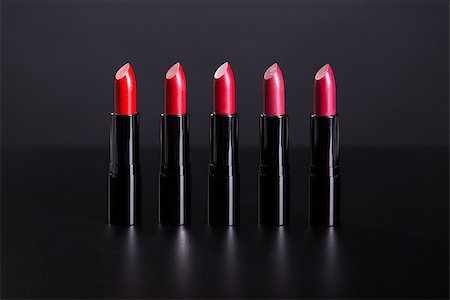 Set of bright lipsticks in shades of red color, studio shot on black background Stock Photo - Budget Royalty-Free & Subscription, Code: 400-08371237