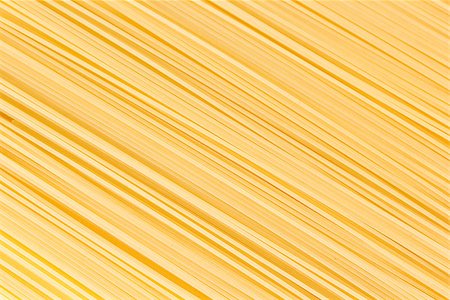 Uncooked spaghetti lie on a diagonal direction Stock Photo - Budget Royalty-Free & Subscription, Code: 400-08371296