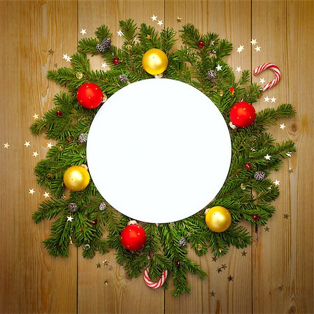 Christmas Decoration Round Frame with firtree, candies and baubles with stars on rustic wood, copy space for text Stock Photo - Budget Royalty-Free & Subscription, Code: 400-08371358