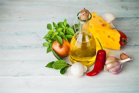 Olive oil with spices and vegetables on wooden board Stock Photo - Budget Royalty-Free & Subscription, Code: 400-08371359