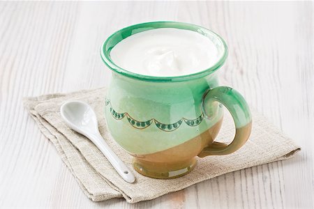 Cup fresh homemade sour cream on wooden background Fotografie stock - Microstock e Abbonamento, Codice: 400-08371840