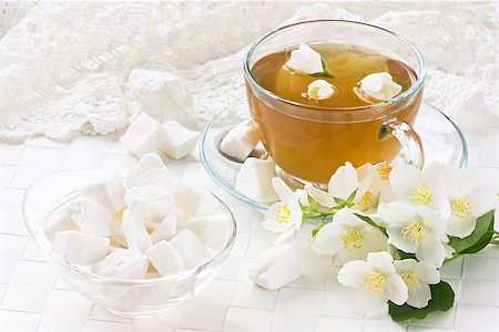 Transparent cup jasmin tea with lump sugar and jasmine flower Fotografie stock - Microstock e Abbonamento, Codice: 400-08371861