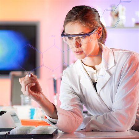 Life science researcher working in laboratory. Portrait of a confident female health care professional in his working environment writing structural chemical formula on a glass board. Stock Photo - Budget Royalty-Free & Subscription, Code: 400-08371902