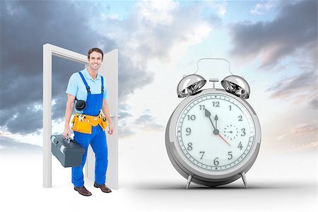 Happy plumber carrying tool box against alarm clock counting down to twelve Stock Photo - Budget Royalty-Free & Subscription, Code: 400-08380052