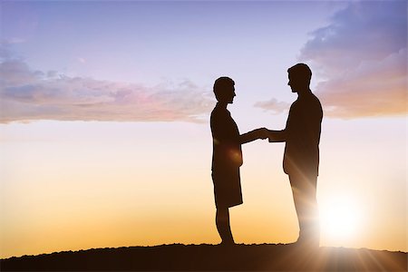 Silhouettes shaking hands against sun shining Stock Photo - Budget Royalty-Free & Subscription, Code: 400-08380165