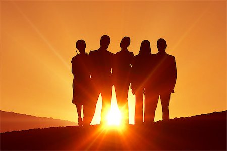 Silhouettes standing against a sun set Stock Photo - Budget Royalty-Free & Subscription, Code: 400-08380166