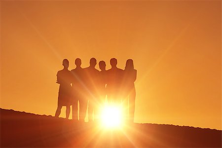 Silhouettes standing against a sun set Stock Photo - Budget Royalty-Free & Subscription, Code: 400-08380167