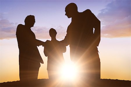 Silhouettes shaking hands against sun shining Stock Photo - Budget Royalty-Free & Subscription, Code: 400-08380195