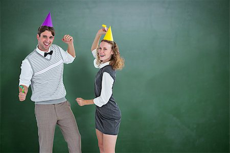 simsearch:400-08380794,k - Geeky couple dancing with party hat  against green chalkboard Stockbilder - Microstock & Abonnement, Bildnummer: 400-08380636