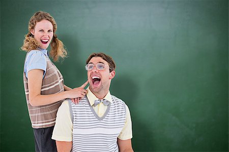 simsearch:400-08380794,k - Excited geeky hipster couple  against green chalkboard Stockbilder - Microstock & Abonnement, Bildnummer: 400-08380651