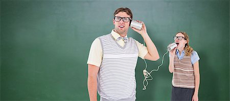 Geeky hipster couple speaking with tin can phone  against green chalkboard Stock Photo - Budget Royalty-Free & Subscription, Code: 400-08380666