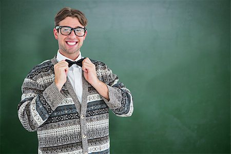 simsearch:400-08380794,k - Happy geeky hipster with wool jacket  against green chalkboard Stockbilder - Microstock & Abonnement, Bildnummer: 400-08380684