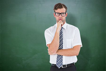 simsearch:400-08076534,k - Serious geeky businessman thinking and holding his chin against green chalkboard Foto de stock - Royalty-Free Super Valor e Assinatura, Número: 400-08380682