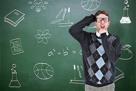 simsearch:400-07682840,k - Geeky hipster frowning at camera against green chalkboard Fotografie stock - Microstock e Abbonamento, Codice: 400-08380808