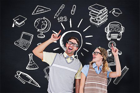 simsearch:400-07684098,k - Happy geeky hipster couple pointing up against blackboard Stock Photo - Budget Royalty-Free & Subscription, Code: 400-08380812