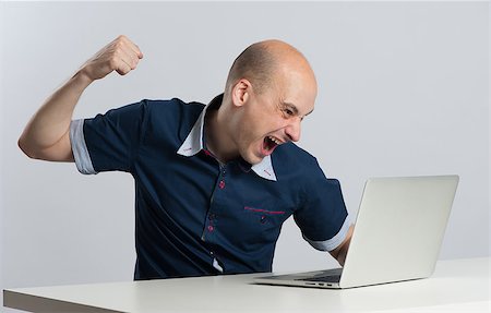 scream computer mad - Furious young businessman about to punch his laptop Stock Photo - Budget Royalty-Free & Subscription, Code: 400-08399853
