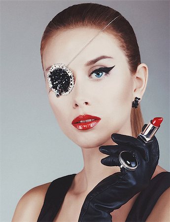 Pretty girl with red lipstick and accessories on the eye grey background Stock Photo - Budget Royalty-Free & Subscription, Code: 400-08399961