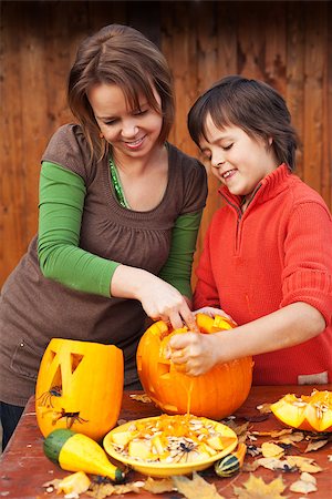simsearch:400-08319221,k - Young boy and woman carving a jack-o-lantern - preparing for halloween Photographie de stock - Aubaine LD & Abonnement, Code: 400-08399999