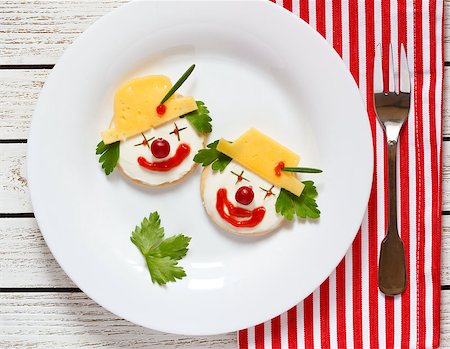 Funny clown two cheese crackers for children breakfast. Stock Photo - Budget Royalty-Free & Subscription, Code: 400-08404071