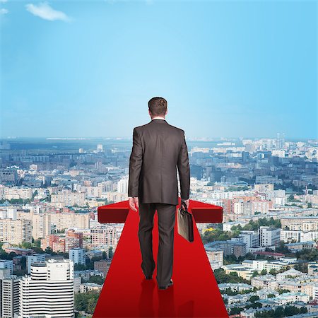 simsearch:400-04486166,k - Businessman on red arrow above city, rear view Stockbilder - Microstock & Abonnement, Bildnummer: 400-08404206