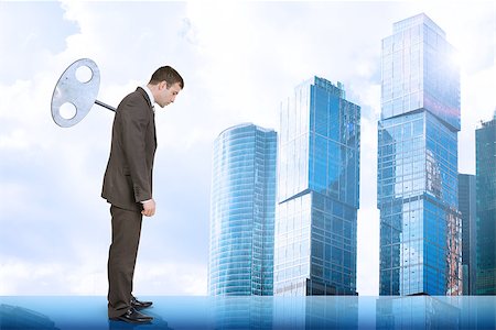 simsearch:400-04486166,k - Businessman looking down with key in back with city background Stockbilder - Microstock & Abonnement, Bildnummer: 400-08404216