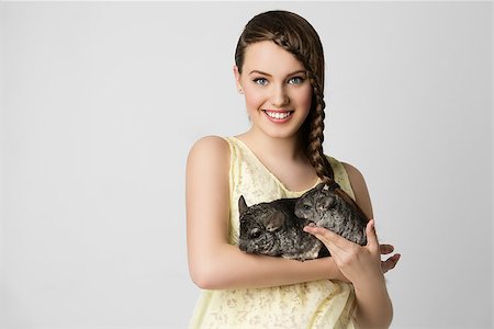 simsearch:400-05352235,k - Beautiful teenage girl holding two chinchillas. Copy space. Photographie de stock - Aubaine LD & Abonnement, Code: 400-08404404