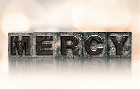 The word "MERCY" written in vintage ink stained letterpress type. Photographie de stock - Aubaine LD & Abonnement, Code: 400-08404848