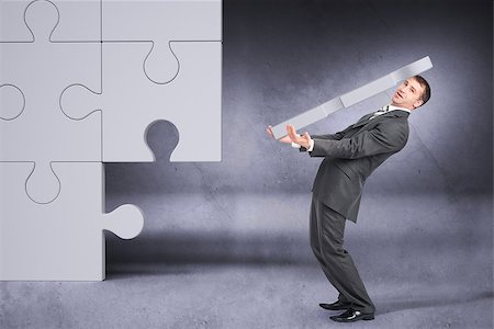 simsearch:400-04486166,k - Businessman holding big puzzle piece on grey background Stockbilder - Microstock & Abonnement, Bildnummer: 400-08405675