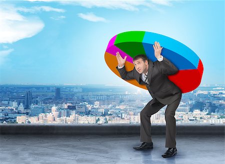 simsearch:400-04486166,k - Businessman in suit holding heavy colorful diagram Stockbilder - Microstock & Abonnement, Bildnummer: 400-08405677