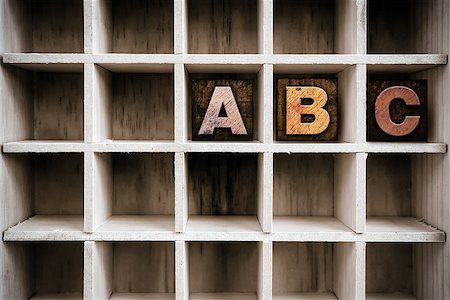 simsearch:400-08407055,k - The letters "ABC" written in vintage ink stained wooden letterpress type in a partitioned printer's drawer. Foto de stock - Super Valor sin royalties y Suscripción, Código: 400-08406129