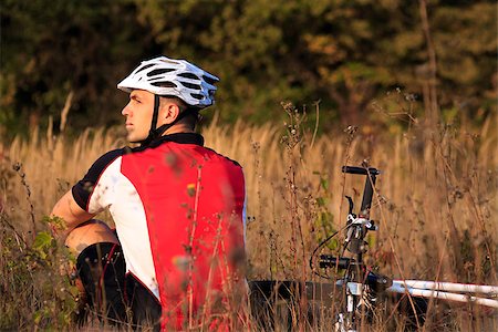 Mountain Bike cyclist resting outdoor sitting on grass Stock Photo - Budget Royalty-Free & Subscription, Code: 400-08406367