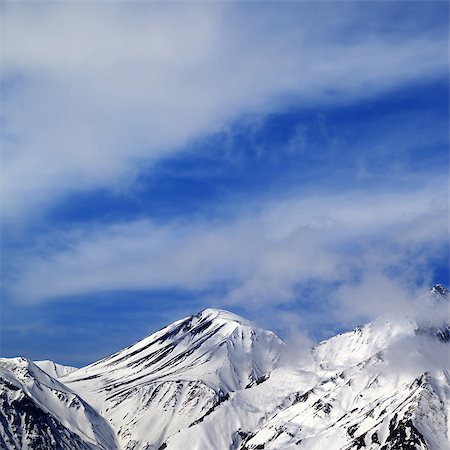 simsearch:400-09170509,k - Winter snowy mountains and sky with clouds at nice day. Caucasus Mountains, Georgia, ski resort Gudauri. Photographie de stock - Aubaine LD & Abonnement, Code: 400-08406773