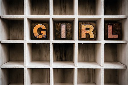 The word "GIRL" written in vintage ink stained wooden letterpress type in a partitioned printer's drawer. Foto de stock - Super Valor sin royalties y Suscripción, Código: 400-08407034