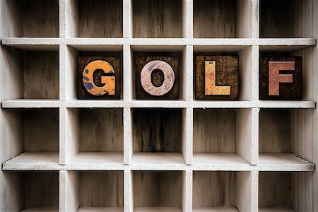 The word "GOLF" written in vintage ink stained wooden letterpress type in a partitioned printer's drawer. Stock Photo - Budget Royalty-Free & Subscription, Code: 400-08407040