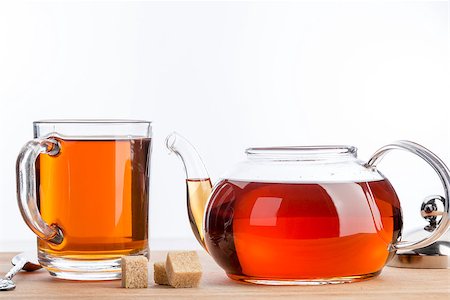 simsearch:659-03533716,k - Teapot and cup of black tea on wood table background. Stock Photo - Budget Royalty-Free & Subscription, Code: 400-08407514