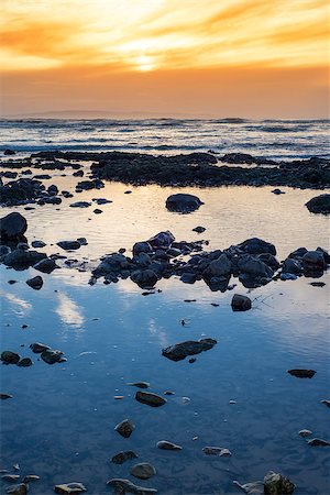 simsearch:400-08370946,k - reflections at rocky beach near ballybunion on the wild atlantic way ireland with a beautiful yellow sunset Photographie de stock - Aubaine LD & Abonnement, Code: 400-08407670