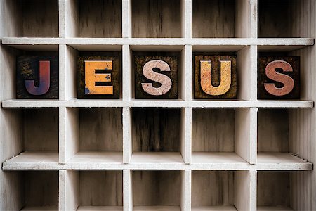 The word "JESUS" written in vintage ink stained wooden letterpress type in a partitioned printer's drawer. Stock Photo - Budget Royalty-Free & Subscription, Code: 400-08408128