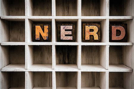 simsearch:400-08407055,k - The word "NERD" written in vintage ink stained wooden letterpress type in a partitioned printer's drawer. Foto de stock - Super Valor sin royalties y Suscripción, Código: 400-08408167