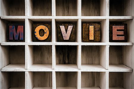 simsearch:400-08407055,k - The word "MOVIE" written in vintage ink stained wooden letterpress type in a partitioned printer's drawer. Foto de stock - Super Valor sin royalties y Suscripción, Código: 400-08408162