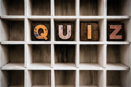 simsearch:400-08407055,k - The word "QUIZ" written in vintage ink stained wooden letterpress type in a partitioned printer's drawer. Foto de stock - Super Valor sin royalties y Suscripción, Código: 400-08408195