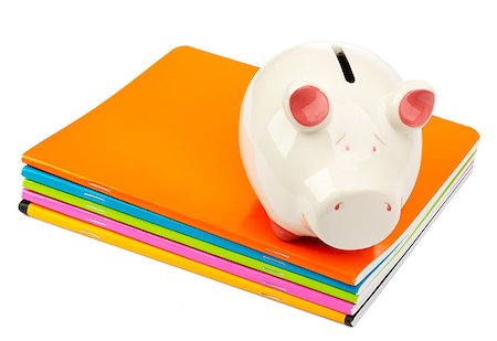 Piggy bank on pile of copybooks on isolated white background Stock Photo - Budget Royalty-Free & Subscription, Code: 400-08408820