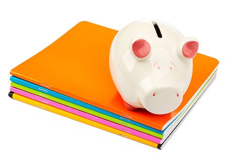 simsearch:400-07260336,k - Piggy bank on pile of copybooks on isolated white background Foto de stock - Super Valor sin royalties y Suscripción, Código: 400-08408820