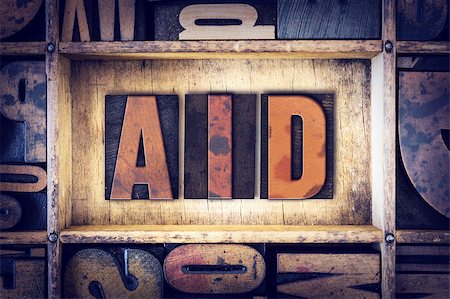 simsearch:400-08161047,k - The word "Aid" written in vintage wooden letterpress type. Stock Photo - Budget Royalty-Free & Subscription, Code: 400-08409428