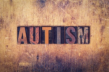 The word "Autism" written in dirty vintage letterpress type on a aged wooden background. Stockbilder - Microstock & Abonnement, Bildnummer: 400-08409448