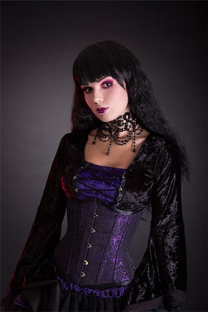 simsearch:400-07776243,k - Attractive gothic girl in Victorian style clothes, studio shot on black background Fotografie stock - Microstock e Abbonamento, Codice: 400-08400058
